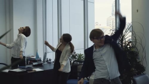 Business Colleagues Dancing in Office Celebrating Success