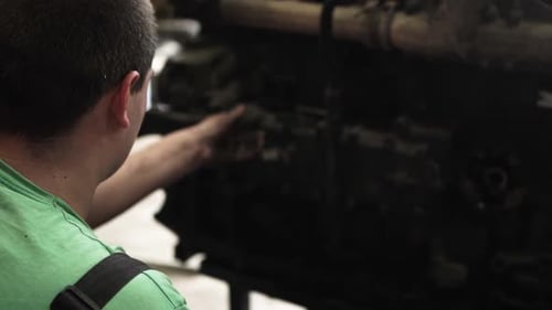 Mechanic Repairs Dirty Industrial Engine Close Up