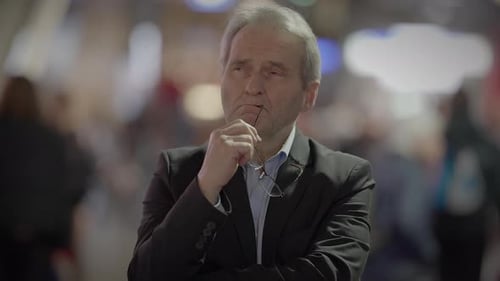 Man in Suit Contemplates in Busy Urban Setting