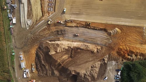 Aerial View of Construction Site with Heavy Machinery and Workers