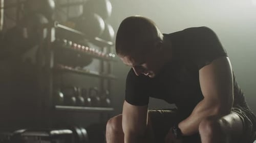 Powerful man lifts dumbbell