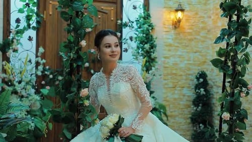 Bride in Elegant White Gown With Bouquet