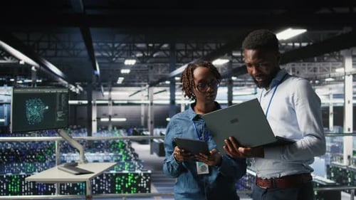 Data Center System Administrators Using Laptop to Review AI LLM Visualizations