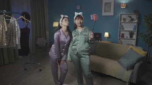 Two Friends Posing for Selfie in Pajamas at Home
