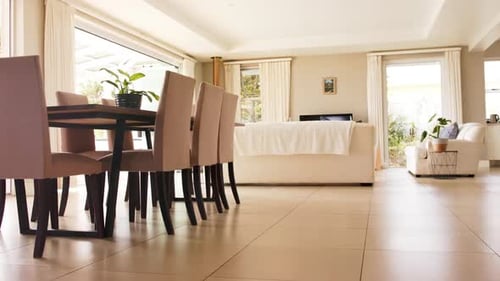 General view of light modern interiors with dining room table and chairs, copy space, slow motion