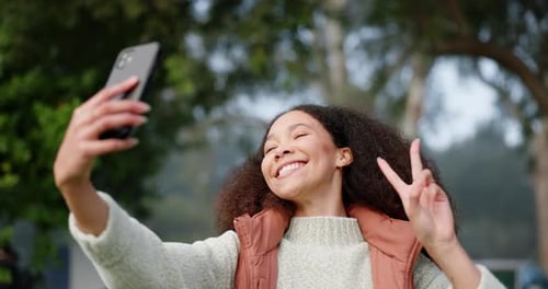 Woman, selfie or live stream, camping outdoor and influencer, peace hand sign and happy in nature