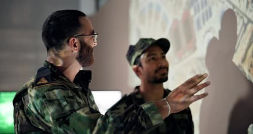 Military Personnel Analyzing Image in Office