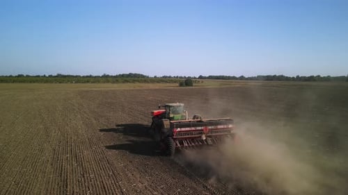 Tractor on the field seeding wheat