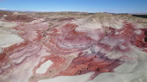 Drone flying over unique geology in Bentonite Hills, sunny day in Utah, USA