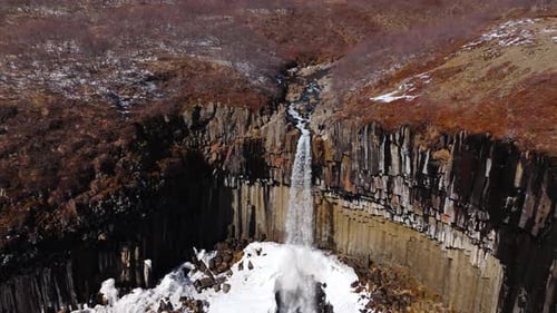 Waterfall Flows Over Basalt Columns in Winter