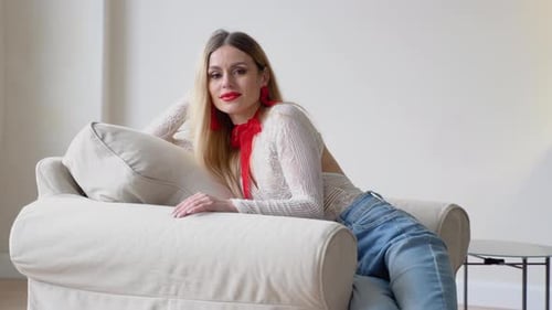 Blonde Woman in Bodysuit Relaxing on Couch