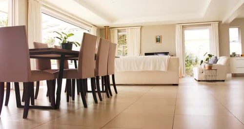 General view of light modern interiors with dining room table and chairs, copy space, slow motion