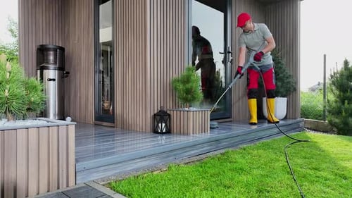 Cleaning the Patio and Garden With Pressure Washer on a Sunny Afternoon