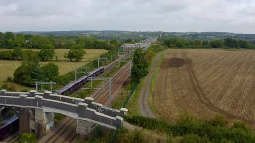 Passenger Train Travels Through a Green Landscape
