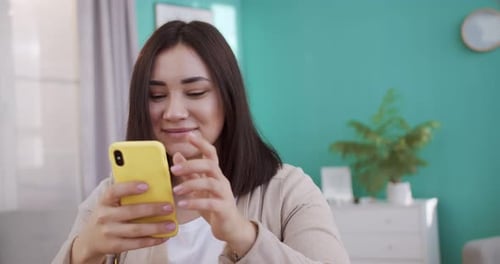 Woman Using Smartphone Indoors