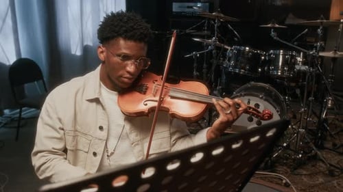 Young Man Plays Violin in Recording Studio