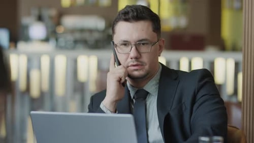 Businessman Having Phone Talk in Restaurant