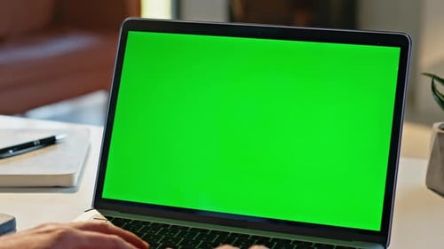 Typing on a Laptop With Green Screen