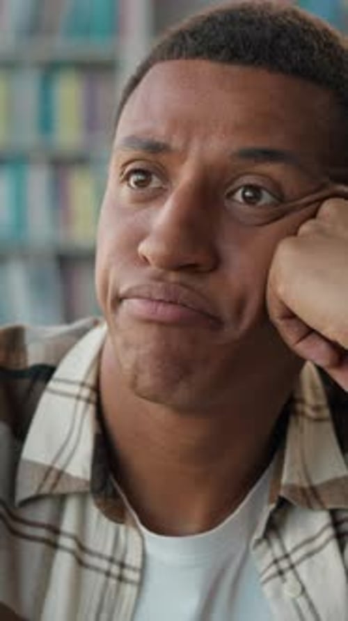 Bored Unhappy African American Man Male Student in Library Tired Guy Looking Away in Boredom Study