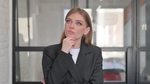 Portrait of Pensive Young Businesswoman Thinking New Idea
