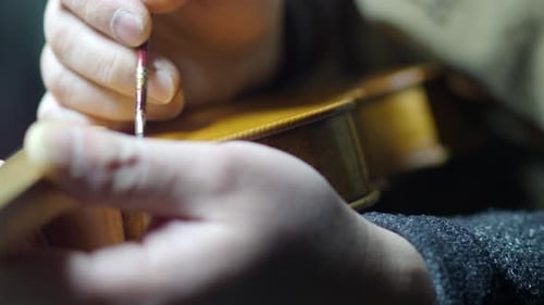 Luthier Antiquing Violin Purfling With Brush in Close-Up Handcrafted Detailing