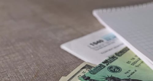 United State 1040 Individual Tax Income Form Pen Calculator on the Desk