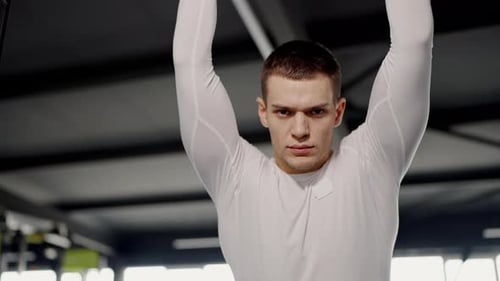 Determined bodybuilder with confident look in sport club during training session