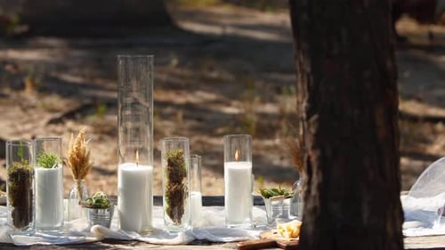 Wedding Party Banquet Outdoors in Forest Dining Table Decorated in Boho Style with Candles White