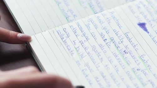 Person Writing in Notebook in Close Up Shot
