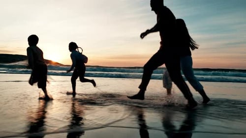 Splash, water and family running on beach at sunset playing with freedom, energy and silhouette