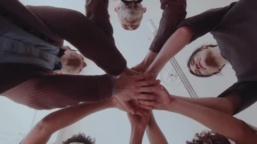 Group of People stacking Hands in Circle
