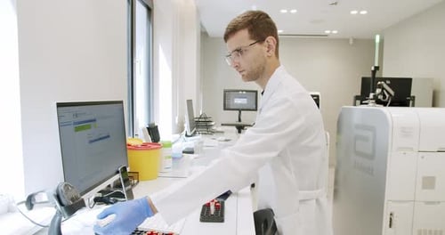 Man Using Computer in Clinic Lab