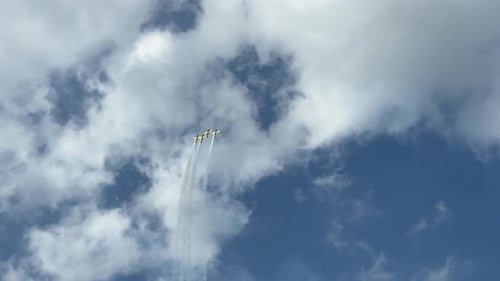 Formation of Four Propeller Airplanes Performing Synchronized Aerial Acrobatics