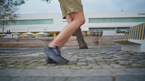 Sportsman Sneakers Running Outdoors Closeup Fit Guy Training in City Park