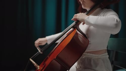Young Woman Plays Cello in Studio