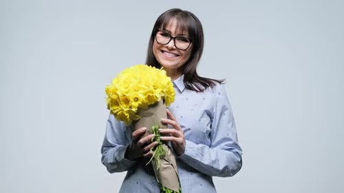 Woman Holding Yellow Daffodils Flower Bouquet Smiling