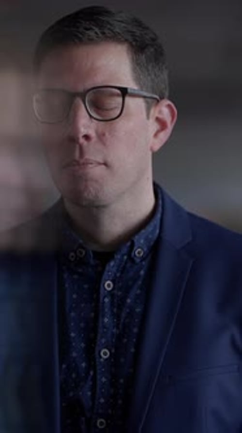 A Professional in a Stylish Blazer Embodies Confidence in a Modern Creative Office Setting