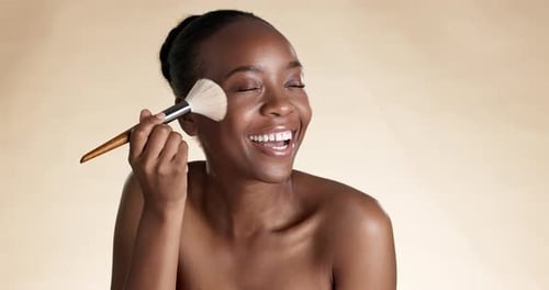 Face, cheek and blush with a model black woman in studio on a brown background to apply makeup