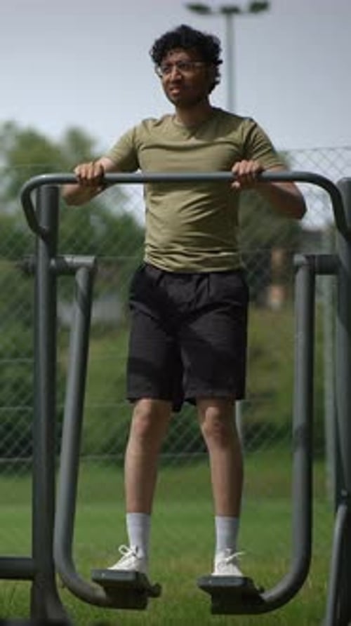 Outdoor Fitness A Young Man Engaging in Physical Exercise in a Picturesque Park Setting