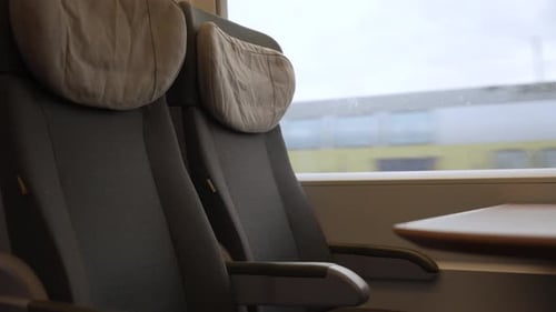 Train interior with seats by window.