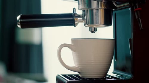 Concept Drinking Roasted Black Coffee in the morningPouring Coffee Stream From Machine in Cup