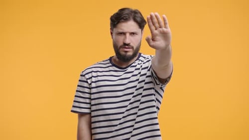 Man With Hand Up Making a Stop Gesture