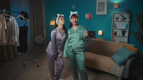 Young Adults in Pajamas Taking Selfies at Home