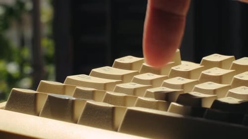 Finger Tapping Keys on Vintage Computer Keyboard