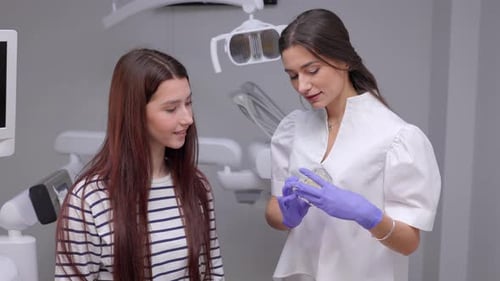 Girl patient sitting on chair at dentist office in dental clinic. Healthy teeth and medicine concept