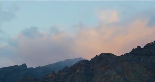 Los Gigantes mountain peaks at sunset. Cloudy sky, dusk. Tenerife, Canary Islands, Spain. Volcanic r