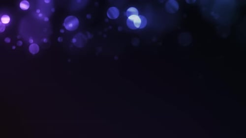 Glamour Collection: Blue flickering bokeh falling from top with copy space on a dark background