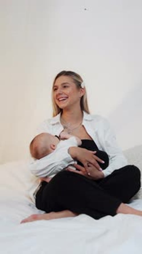 Woman Breastfeeding Infant in Home Setting