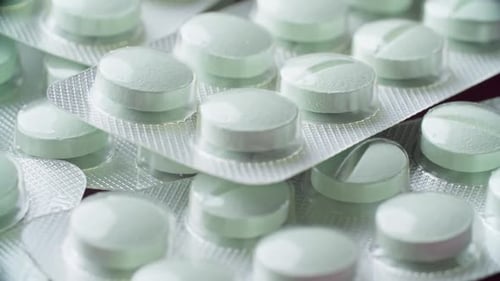 Blisters with Medicines on Table Rotating Variety of Pharmaceutical Pills