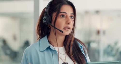 Smiling Woman Wearing Headset Speaking at Work